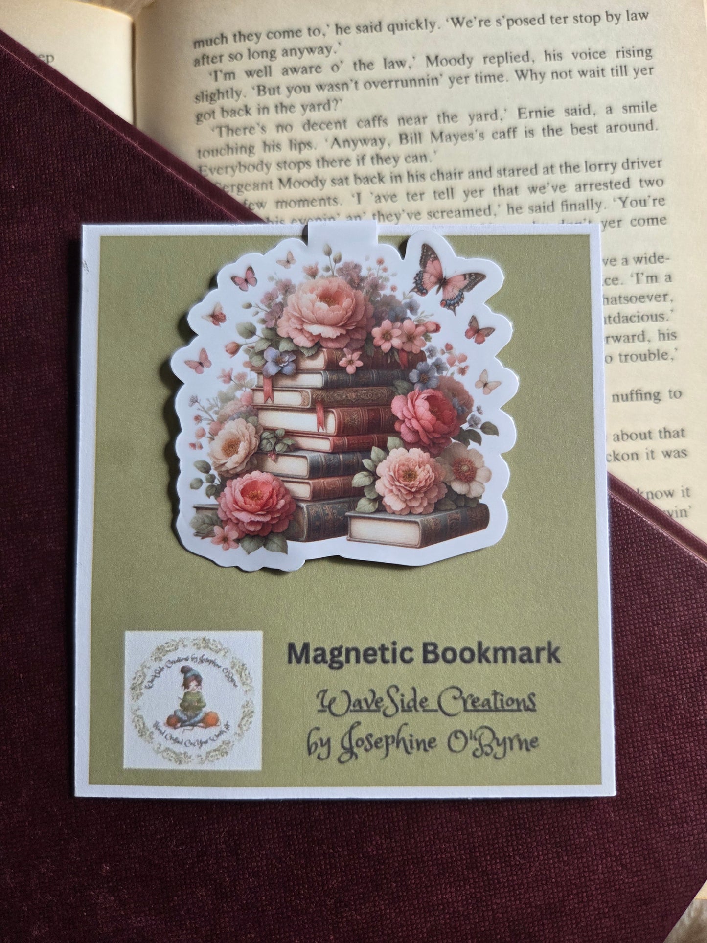Magnetic bookmark, roses and butterfly's on a stack of books