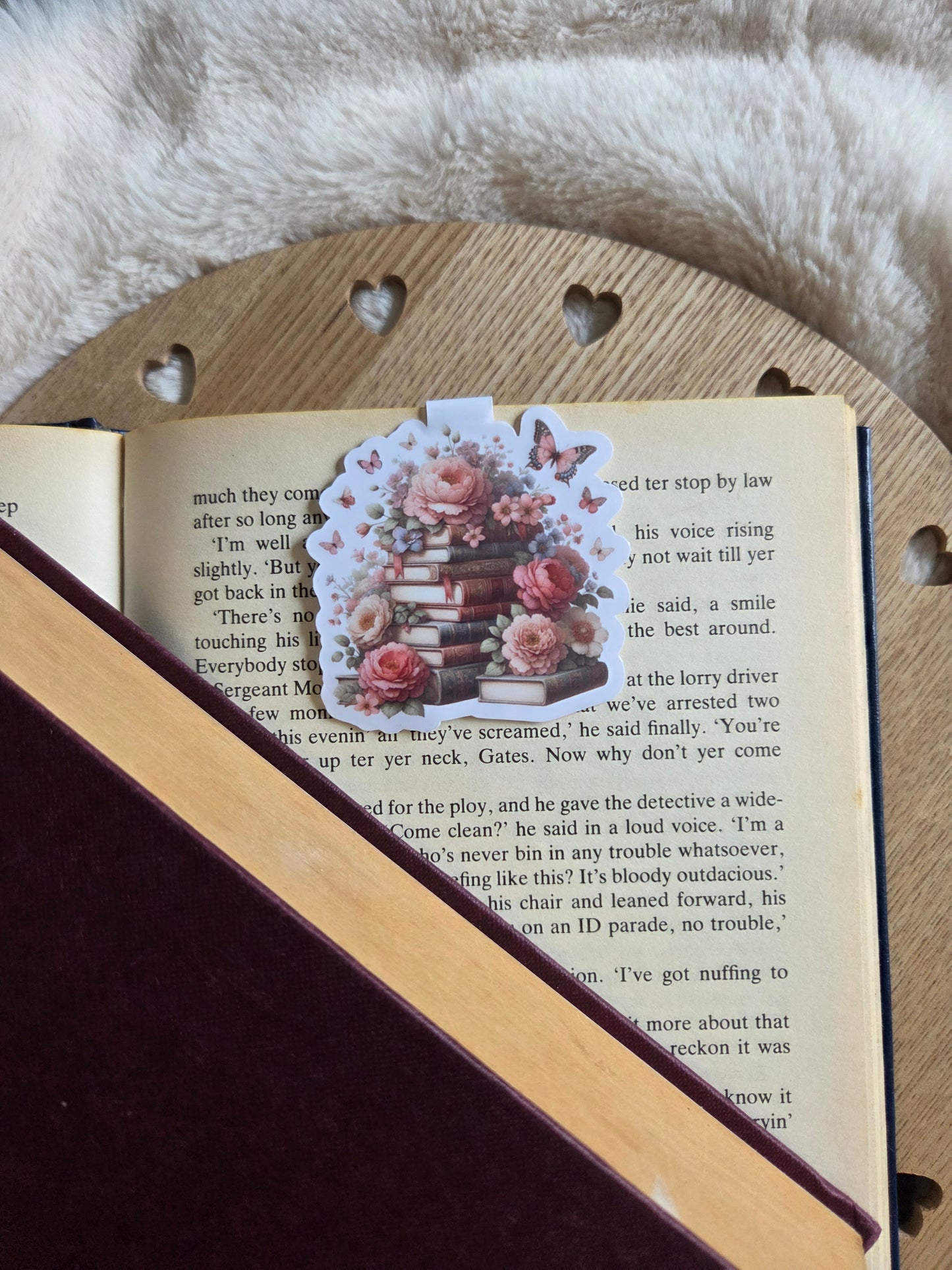 Magnetic bookmark, roses and butterfly's on a stack of books