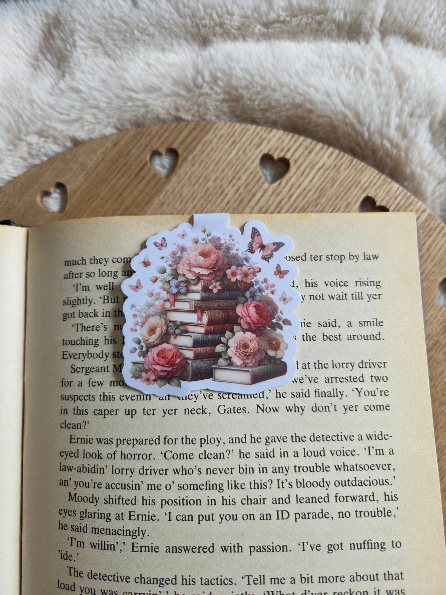 Magnetic bookmark, roses and butterfly's on a stack of books